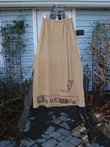 Image alt text: "1998 Scrabble Skirt Games Bamboo Size 2: A skirt with a cartoon Scrabble theme, featuring a waistline with folded front and rear elastic, horizontal panels, a lower banded wider sweep, and two upper finger pockets."