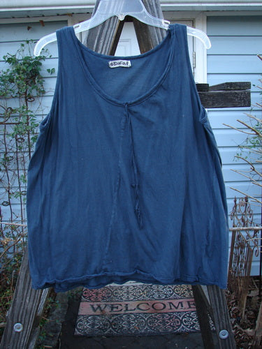 A blue tank top on a clothesline, featuring a shorter A-line shape, front neckline tie, and diagonal insert. Barclay Batiste Decora Tiny Tank Unpainted Navy Size 2.