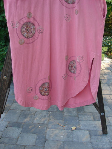 Barclay Naiad Dress Medallion Glow Size 2: A pink dress with a super rounded and vented hemline, featuring a rear draw cord and shorter sectional lower sleeves.