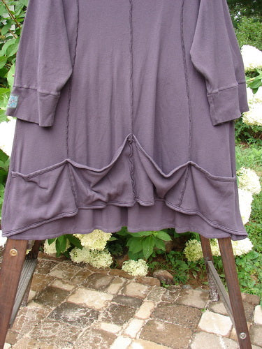 Barclay Patched Thermal Quad Drop Pocket Tunic Dress Plum Size 2: A whimsical nature-themed dress with a double layered flop turtleneck, widening lower hem, and four generous drop pockets. Varying hemline and exterior curved stitchery. Made from cotton thermal. Bust 54, waist 56, hips 60. Front length 35, back length 40.