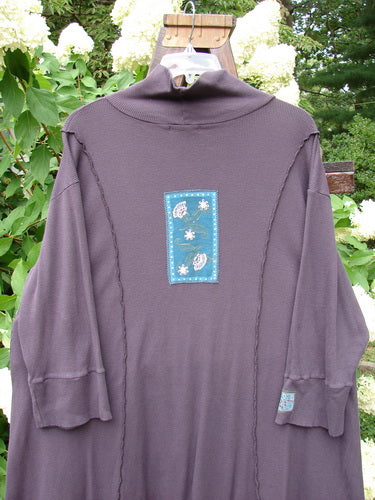A long sleeved shirt with a patch on it, part of the Barclay Patched Thermal Quad Drop Pocket Tunic Dress Plum Size 2.