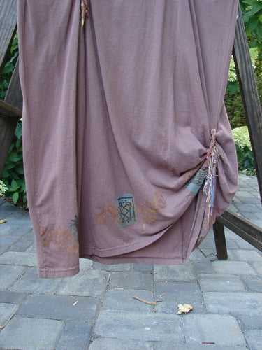 1994 Deep Neck Dress with fish embellishments, silk ribbons, and cotton ties on a wooden stand. Size 2, dusty plum color.