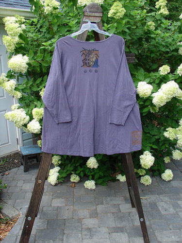1996 Triangle Cardigan Garden Bug Purple Martin OSFA: A purple shirt with a bug design, featuring a deep V neckline, angled front pockets, and a scooped hemline. Made from organic cotton.