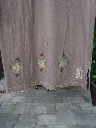 1999 Straight Dress Nesting Bowls Riverbed Size 1: A brown cloth with circles, featuring a rounded neckline, side entry pockets, and a vented hemline. Made from organic cotton.