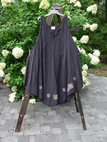 2000 Lace Up Jumper Pinwheel Raven Size 2: A black dress on a clothesline with a seriously varying hemline and a laced front.