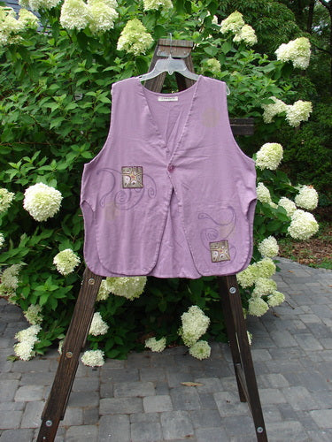 1997 Elements Dock Vest Ocean Life Jasmine Size 2: A purple vest on a wooden stand with a design. Medium weight organic cotton, single button closure, signature patch, high vented rounded sides, draw cord back, double layered cotton. Bust 52, waist 54, hips 60, length 30.