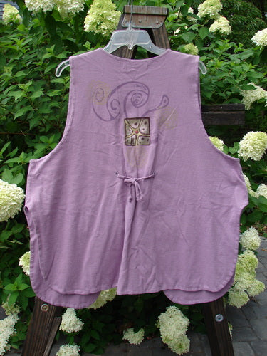 1997 Elements Dock Vest Ocean Life Jasmine Size 2: A purple vest with a design on it. Single button closure, signature patch, high vented rounded sides, draw cord back, double layered medium weight cotton. Bust 52, waist 54, hips 60, length 30.