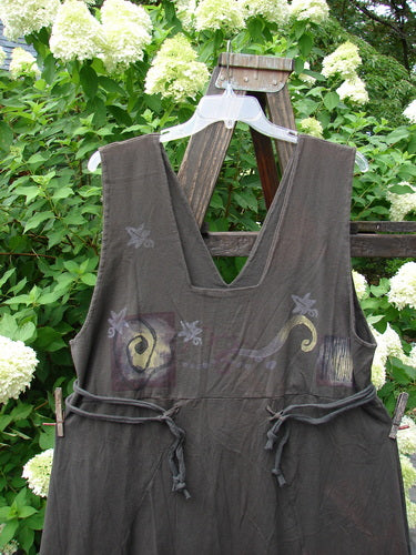 1994 Scroll Jumper Wind Edo Black OSFA: A black dress on a wooden rack, featuring a double-paneled upper, deep arm openings, and a widening lower skirt.