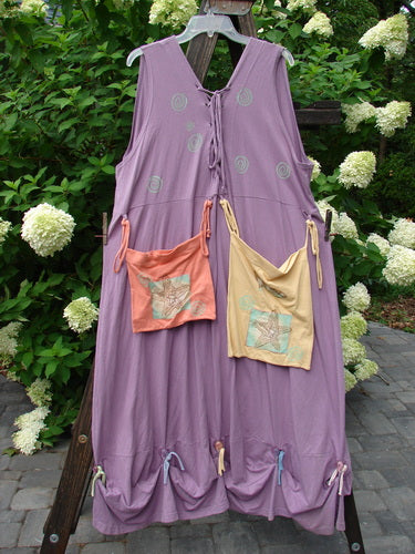 1997 Salt Water Taffy Jumper: A purple dress with pockets and bags, adorned with buttons and ties. Perfect for summer with an ocean theme. Size 2.