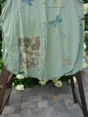 1995 Breeze Vest Water Can Dinette Green OSFA: A green shirt on a clothes rack, featuring a deep V-shaped neckline and a front painted breast pocket.