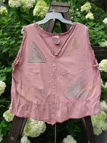 1995 Wish Vest Ocean Shell Heart Size 2: Pink shirt with pattern, antique lace accents, and adjustable hemline. Close-up of a plant in the background.