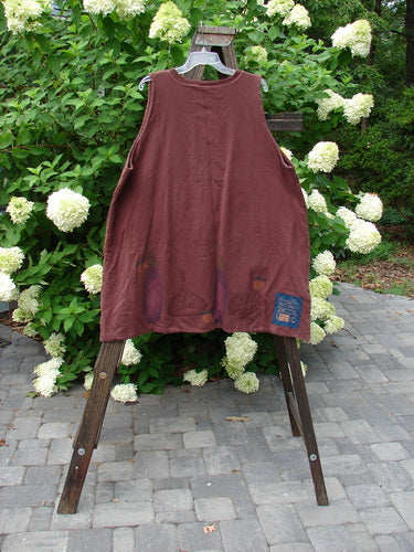 1998 Basil Vest Bountiful Harvest Peat OSFA: A red vest on a rack with a shirt tail hemline, A-line shape, ribbed V-neck, blue fish buttons, and a signature patch.
