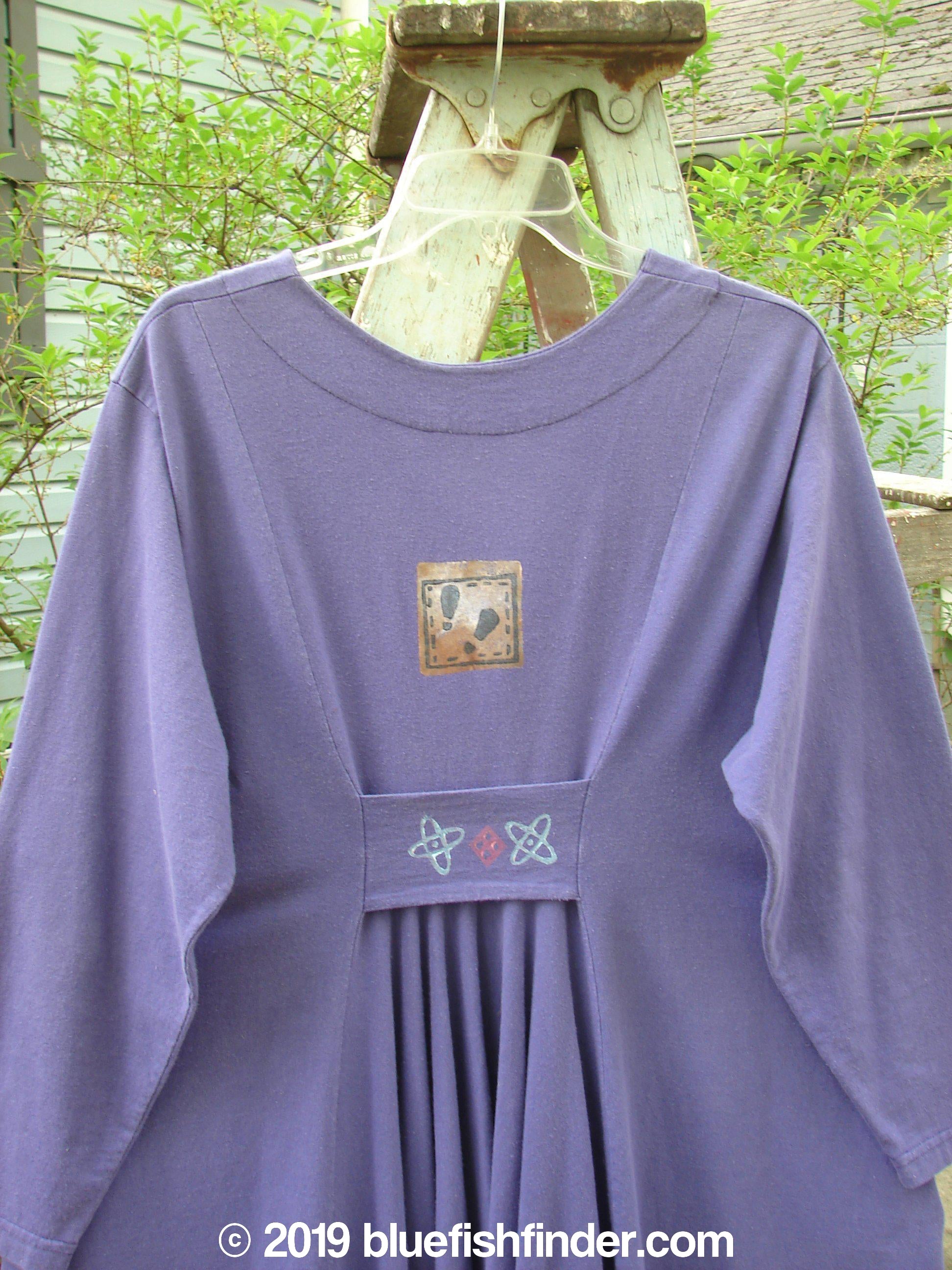 1996 Dining Car Jacket Travel Niagara Size 1: A purple dress with a logo on it. Features include swing hemline, deep V neckline, and artisan buttons.