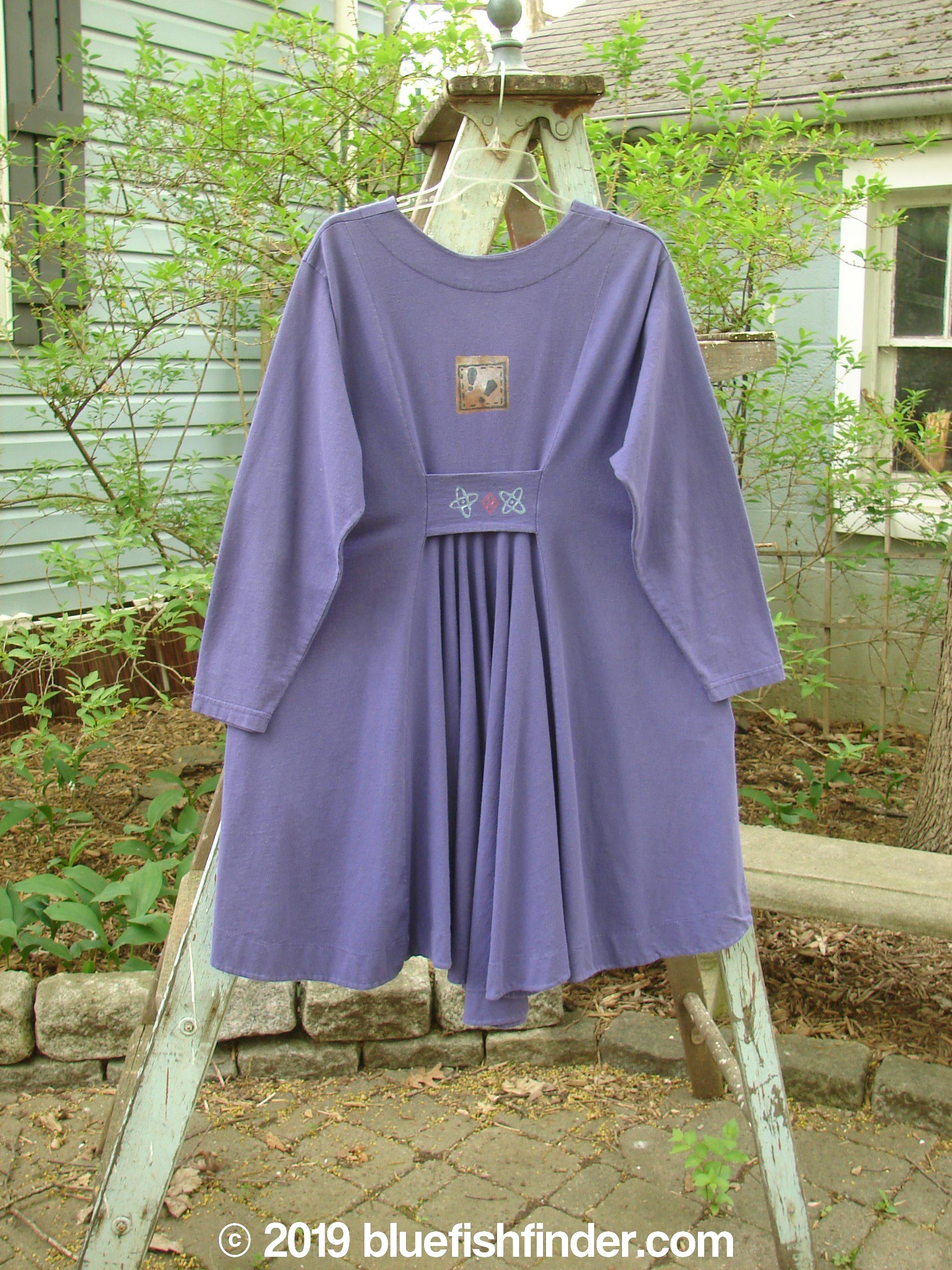 Image alt text: "1996 Dining Car Jacket Travel Niagara Size 1: Purple dress on a clothes rack, featuring a V-shaped neckline, artisan porcelain buttons, and deep side pockets."
