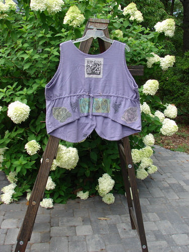 1993 The Vest Mushroom Garden Periwinkle Size 1: A vintage oversized cotton vest with tuxedo-style front tails, blue fish buttons, and a crop draw corded back. Features a heart signature 93 patch and a mushroom garden theme paint.
