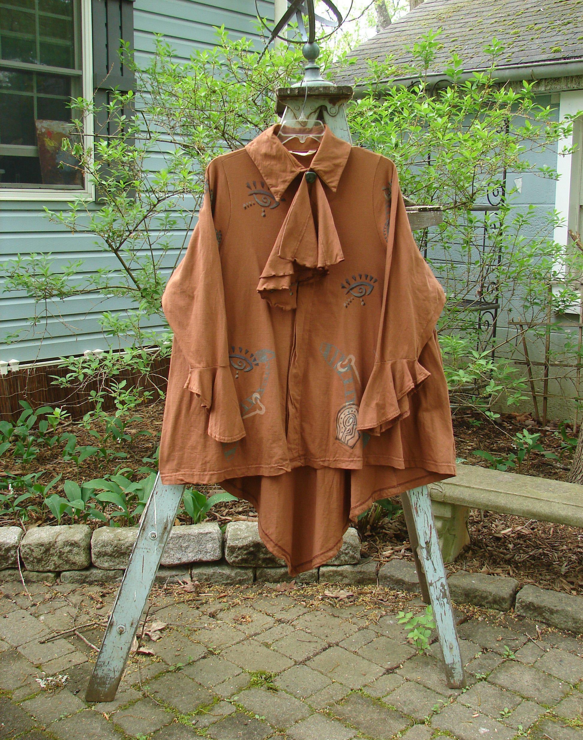 1996 Flutter Jacket Abstract Cassia Size 2: A brown jacket with a unique hidden button front and a triangular painted removable flounce. Features flutter sleeves, a pointed ruffled rear hemline, and generous hip measurements. Made from organic cotton.