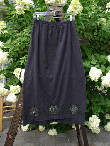 1999 Winter Skirt Celtic Five Raven Size 2: A black skirt on a wooden pole, featuring a lower peg shape and a fun twist to a straight skirt.