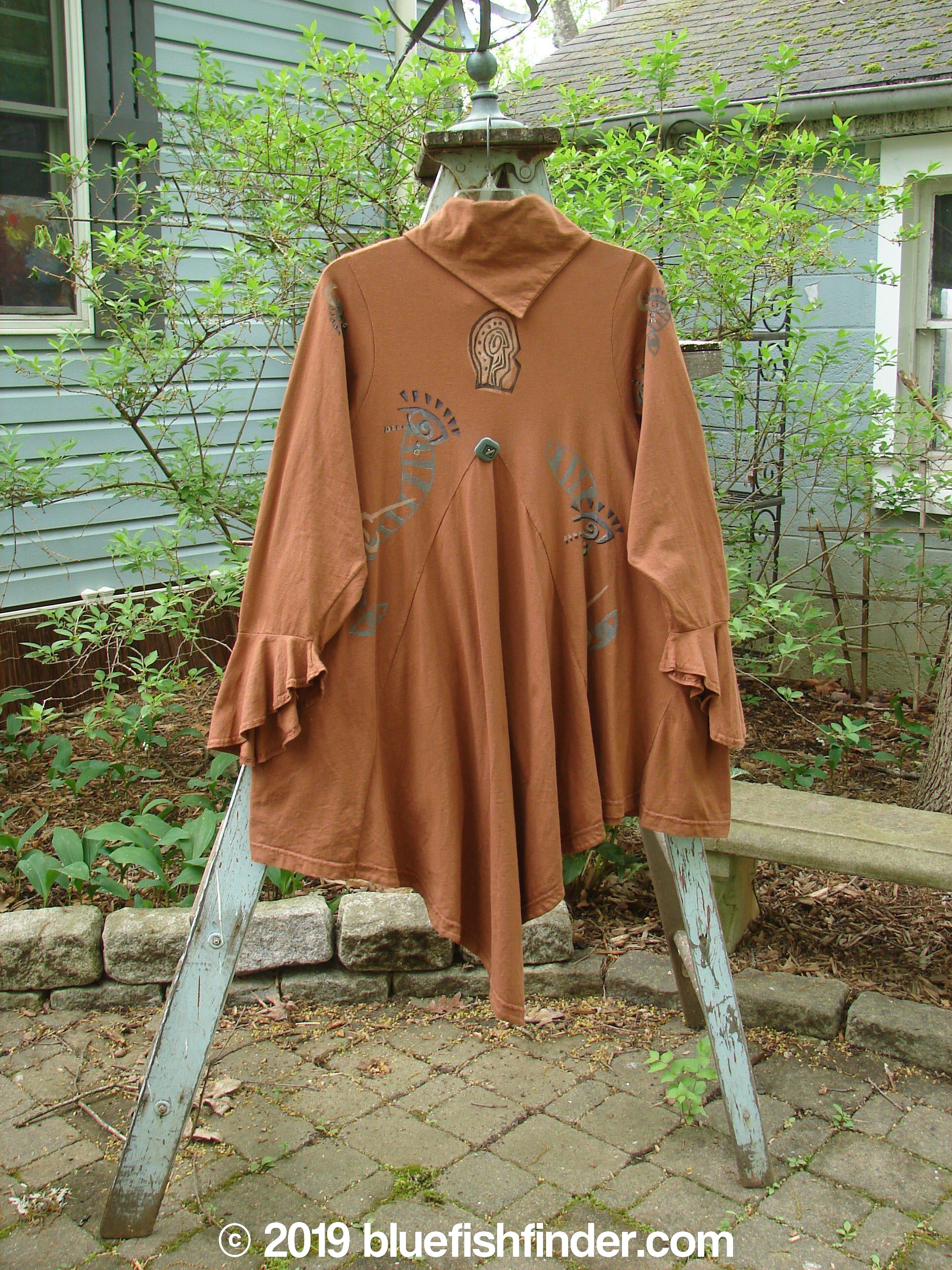 1996 Flutter Jacket Abstract Cassia Size 2: Brown jacket on a ladder with unique hidden button front and triangular removable flounce. Flutter sleeves, ruffled rear hemline, and generous hip measurements.