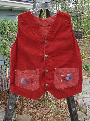 1997 Contractor's Vest with pockets on a wooden stand. Dense cotton rear and corduroy front. Metal stamped buttons, buckle back, and adjustable strap. Angular painted home pockets with tiny metal rivets. Square boxy shape with V neckline and sectional panels. Full Moon theme paint. Bust 42, waist 48, hip 48, front length 27, back length 23 inches.