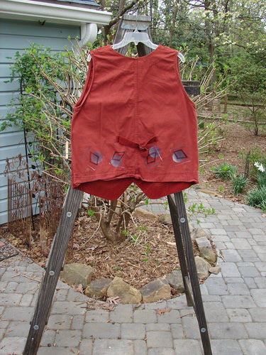 1997 Contractor's Vest in Brick, made from dense cotton. Features include metal buttons, buckle back, and painted home pockets. Bust 42, waist 48, hip 48.