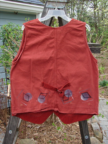 1997 Contractor's Vest Full Moon Brick Size 1: A dense cotton vest with a corduroy front. Features include metal stamped buttons, accent buckle back, and painted home pockets with metal rivets. Bust 42, Waist 48, Hip 48, Front Length 27, Back Length 23.