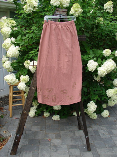 1998 Botanicals Corolla Skirt Digitalis Magnolia Size 1: A skirt on a rack, part of the Spring Botanicals Collection. Made from Organic Cotton, it features a full elastic waistband and a beautifully upward scooped front hemline. A slenderizing, pocket-less design. Waist: 28-44 inches, Hips: 44 inches, Front Length: 34 inches, Back Length: 40 inches.