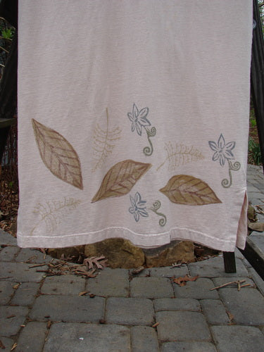 Image alt text: 1999 Straight Dress Window Chair Teadye Size 0: A towel with painted leaves and flowers, featuring a brown leaf on a white surface, and a close-up of a stone walkway.