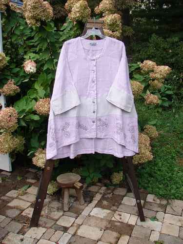 Barclay Linen Wonderland Sectional Banded Cardigan, featuring a purple shirt on a swinger and a close-up of a flower.