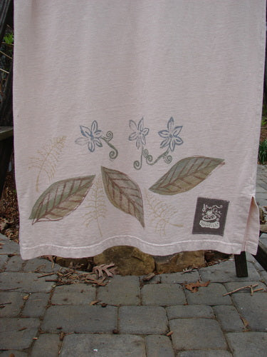 Image alt text: "1999 Straight Dress Window Chair Teadye Size 0: Towel with painted leaves and flowers, black and white logo, stone walkway, wall"