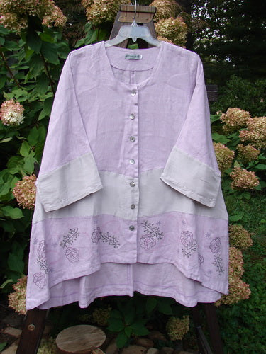 Barclay Linen Wonderland Sectional Banded Cardigan with tiny flower pattern, a light purple shirt with unique panels and belled sleeves.