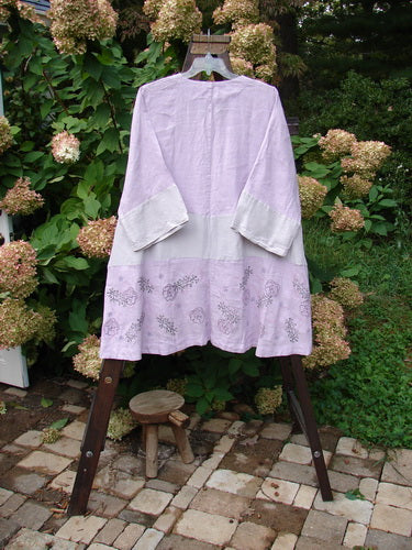 Barclay Linen Wonderland Sectional Banded Cardigan, featuring a lovely dress with a floral design and unique horizontal alternating panels.