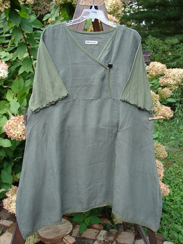 Barclay Linen Lace Blooming Tunic Dress Unpainted Army Size 2: A green dress on a clothesline with lace trim and floral accents.