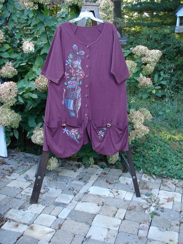 Image alt text: Barclay Short Penny Dress with garden show theme paint and painted pockets, made from organic cotton. Size 2.