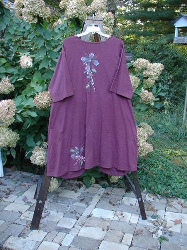 Image alt text: Barclay Short Penny Dress with flower design, swing shape, and painted pockets, made from organic cotton.