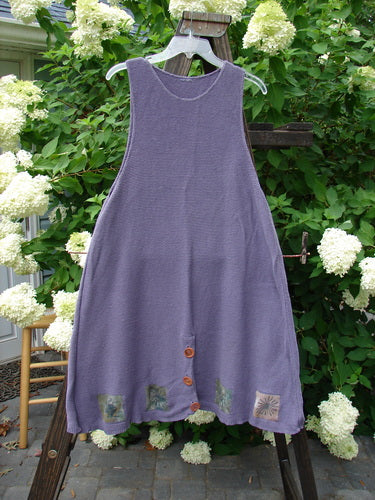 1994 Vent Vest Sweater Jumper Sea Life Periwinkle OSFA: A purple dress on a clothes rack, featuring a slenderizing A-line shape, detailed hemline whimsical nature paint, and rear walking vent.