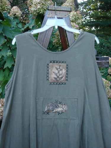 1995 Invention Smock The Garden Snail Bramble OSFA features whimsical snail drawings on medium-weight denim, front pleats, bib pocket, rivet-accented side pockets, and a back painted tunnel pocket, embodying vintage Blue Fish creativity.