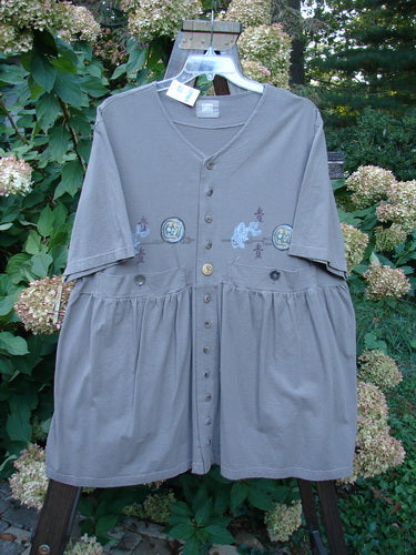 1999 NWT Vintage Button Dress, grey stone, size 1: Baby doll style with pleats, folds, and 11 buttons on the front. Asian theme paint details, A-line shape, and Blue Fish patch. Bust 50, Waist 52, Hips 66, Length 36, Hem Circumference 80.