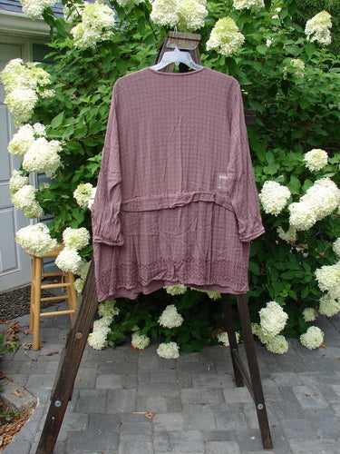 1998 Basket Weave Tencel Bi Level Top Border Band Elderberry Size 2: A shirt on a swinger with a wooden ladder and purple cloth.