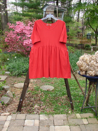 Barclay Studio Boxcar Dress Unpainted Real Red Size 1: A mid-weight organic cotton dress with a rounded neckline, curved waist seam, and flaring lower flounce. Features two side pockets. Length: 36".