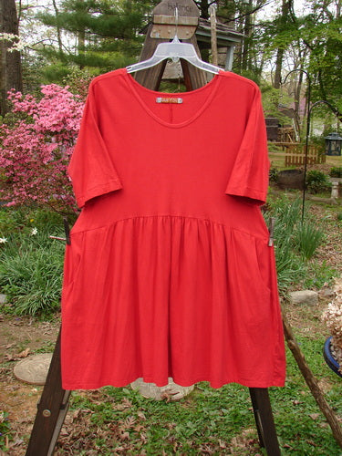 Barclay Studio Boxcar Dress Unpainted Real Red Size 1: A mid-weight organic cotton dress with a rounded neckline, curved waist seam, and flared lower flounce. Features two side pockets. Length: 36 inches.