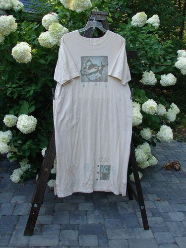 1999 Straight Dress Watering Can Natural Small Size 2: A shirt on a rack with a white sheet on a wooden ladder. Features a drawing of a watering can.
