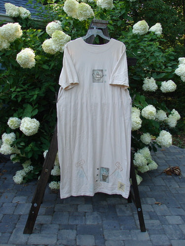 1999 Straight Dress Watering Can Natural Small Size 2: A white shirt with a picture of a watering can on it, featuring rounded side entry front pockets, a paneled neckline, widening hips, and a vented hemline. Made from 100% organic cotton.