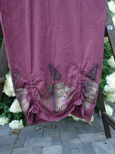 Image alt text: 1993 Deep Neck Button Dress in Woodberry with purple cloth and flower accents