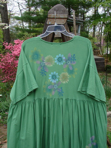 Barclay Tree Top Cardigan Dress, floral blossom design on a green shirt with flowers. Sweet baby doll style, vintage buttons, V neckline, gathered full lower, slight empire waistline, and a lovely peasant look. Perfect condition, made from lightweight organic cotton. Size 3.