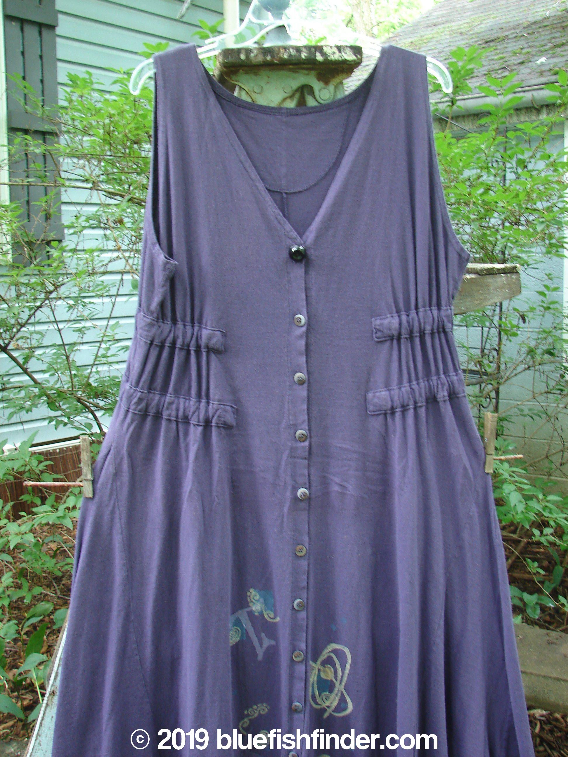 A 1994 Spin Jumper in mixed purple nuit, size 2. Features include an empire waist, tie tunnels, V-shaped neckline, and sweeping hemline.