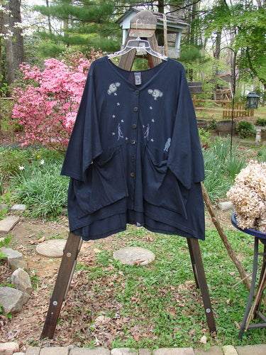 1994 Treasure Jacket with Cloud and Star Theme Paint, featuring a black shirt with a design on it, floppy pockets, and a V-shaped neckline.