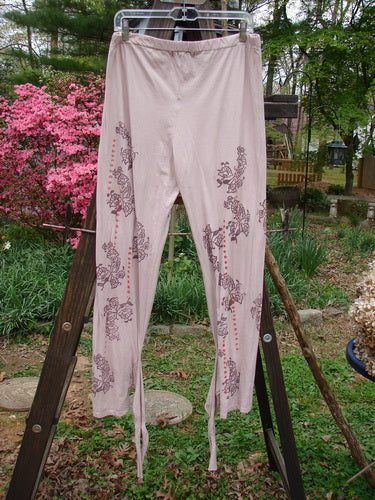 Barclay NWT Batiste Wrap Layering Pant Legging Flower Peach Bisque Size 2: A pair of pants with flowers on them, hanging on a clothesline.