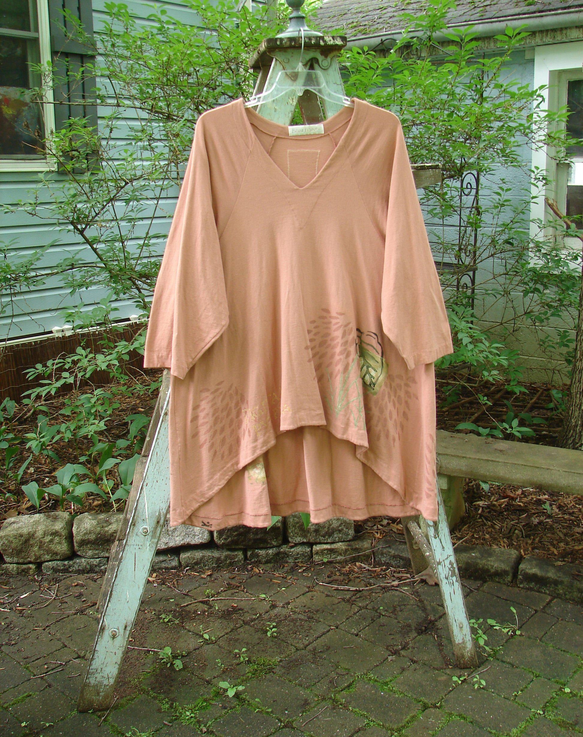 Image alt text: "1998 Botanicals Bell Flower Top Magnolia Size 2: A pink shirt on a clothes rack, featuring a belled A-line shape, sectional panels, and a Blue Fish Signature Patch. Perfect condition, made from organic cotton."

Note: The alt text has been modified to fit within the character limit and to align with the provided product description and store context.