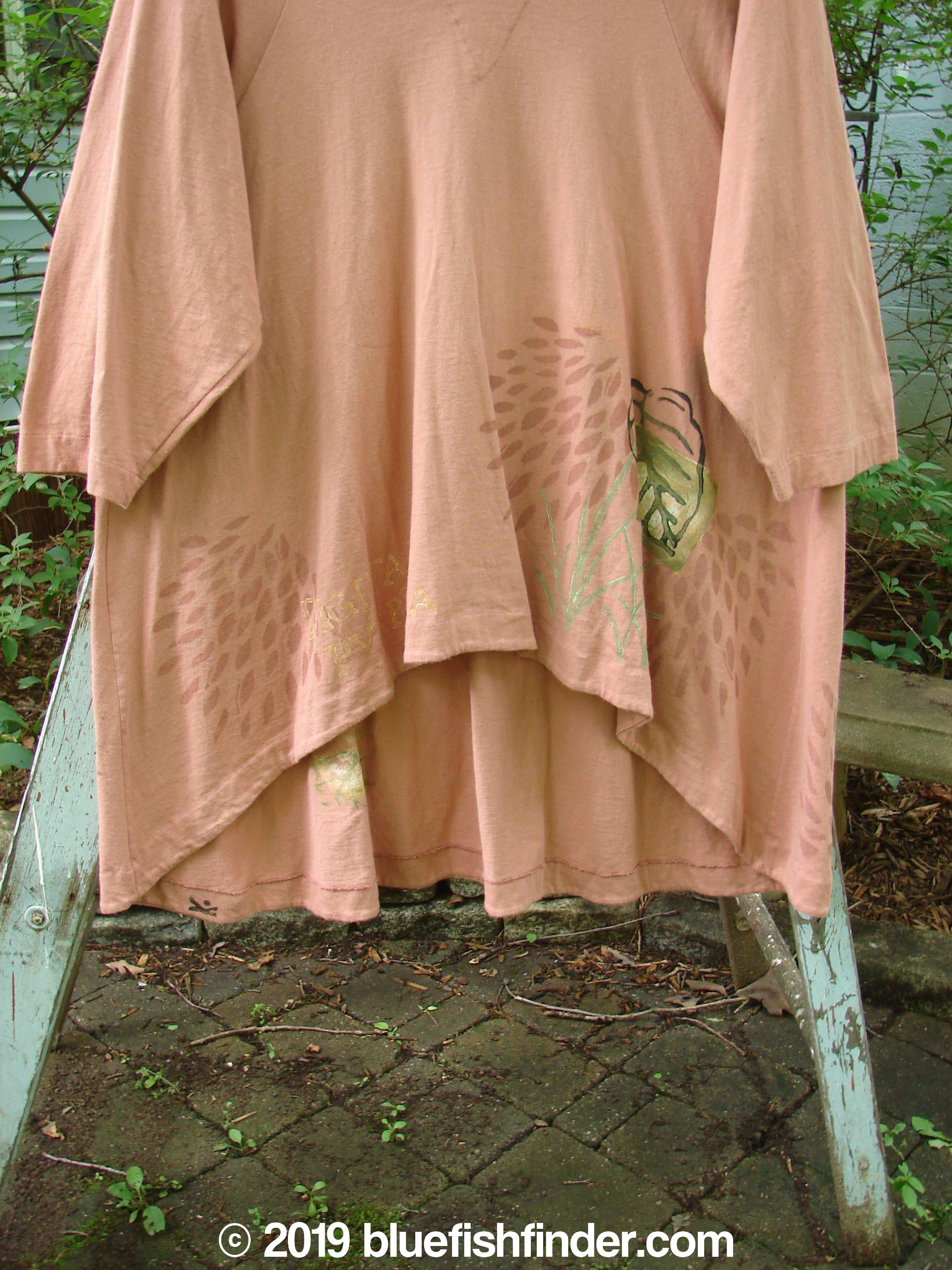 1998 Botanicals Bell Flower Top Magnolia Size 2: A pink shirt on a ladder with a wood beam close-up and plants growing out of a stone surface.