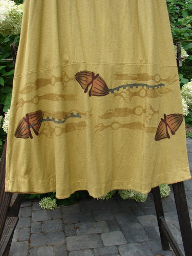 2000 Cotton Hemp Shade Skirt Bio Cell Gold Size 2: A yellow dress with brown designs, featuring a full elastic waistband, varying hemline, and creative adjustments.